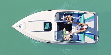 Three men in a motor boat, from above