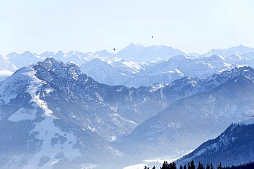 View across the Bavarian Alps from the Kampenwand to Austria with 2 hot air balloons in the distance, Chiemgau, Upper Bavaria, Germany, Europe