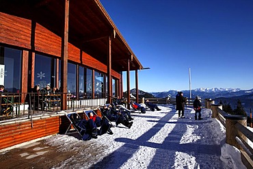 People enjoying the sun on the Sonnen Alm restaurant terrace, Kampenwand, Chiemgau, Upper Bavaria, Germany, Europe