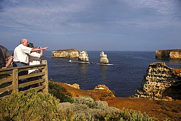 Tourists overlooking the Bay of Isles, Port Campbell National Park, Victoria, Australia