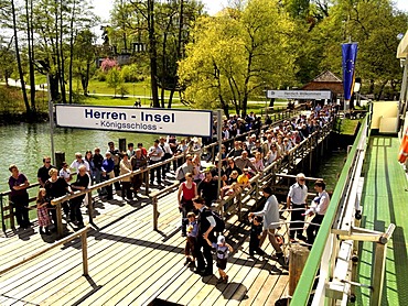 Tourists leaving and waiting to board a ferry boat at Herreninsel island, Chiemgau, Upper Bavaria, Germany, Europe