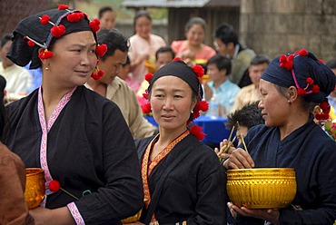 Pi Mai, Lao New Year, Women of the Phunoy ethnic group, traditional dress in black with red pompoms, Phongsali city, Laos, Southeast Asia, Asia