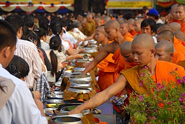 Theravada Buddhism, That Luang Festival, Tak Bat, monks standing behind alms bowls, believers, pilgrims giving alms, orange robes, Vientiane, Laos, Southeast Asia, Asia