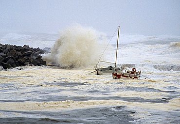 High waves crashing over rocks, rocking small boats, stormy seas on the Brittany coast, hurricane, Finistere, Brittany, France, Europe