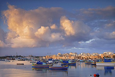 Luzzus, the typical colorful fishing boats of Malta, in Marsaxlokk Harbour, Malta, Europe