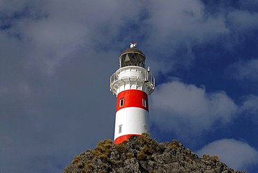 Clouds above Cape Palliser Lighthouse at the Cook Strait at the southern tip of the North Island, New Zealand