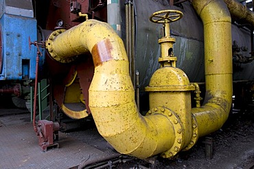 Pipe with wheel in the former steelworks, Landschaftspark Duisburg Nord landscape park, Ruhrgebiet area, North Rhine-Westphalia, Germany, Europe