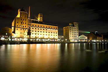 Wehrhahn-Muehle mill and Hafenforum office building in the Innenhafen Duisburg inner harbor at night, Ruhrgebiet area, North Rhine-Westphalia, Germany, Europe