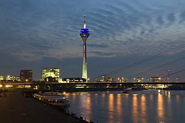 City gate, Rheinturm tower and Rheinkniebruecke bridge at dusk, state capitol Duesseldorf, North Rhine-Westphalia, Germany, Europe