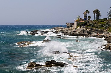 Surf and Rotonda Sant Ampelio Chapel at the cape, Bordighera, Riviera, Liguria, Italy