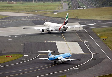 Duesseldorf International Airport, Emirates Airbus A330 on the taxiway to the runway, followed by KLM Cityhopper Fokker 70, Duesseldorf, North Rhine-Westphalia, Germany, Europe