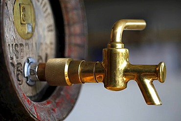 Wood beer keg in a small private brewery, with brass tap