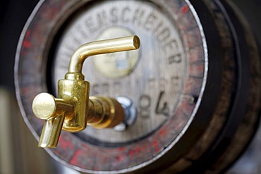 Wood beer keg in a small private brewery, with brass tap