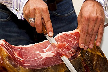 Butcher slicing ham