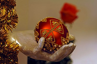 White decorative hand with a red Christmas bauble, Villa Ambiente, Im Weller, Nuremberg, Middle Franconia, Bavaria, Germany, Europe