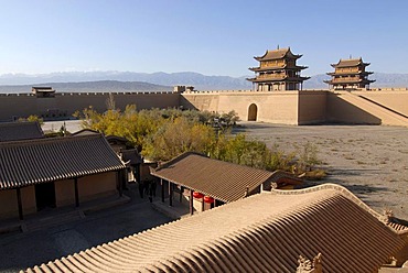 Jiayuguan fortress with two gatehouses at the western end of the Great Wall with trees in autumn colours, Silk Road, Gansu, China, Asia