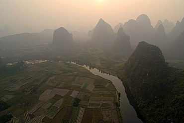 Rocky karst landscape with Yulong River and paddies near Yangshuo, aerial, Guilin, Guangxi, China, Asia