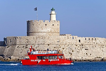 An excursion boat passes the harbor entrance, Rhodes town, Rhodes island, Greece, northern part, Aegean Sea, Southern Europe, Europe