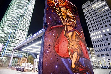 Potsdamer Platz with DB Tower, left, Ritz Carlton, right, and a piece of the wall at night, Berlin, Germany, Europe