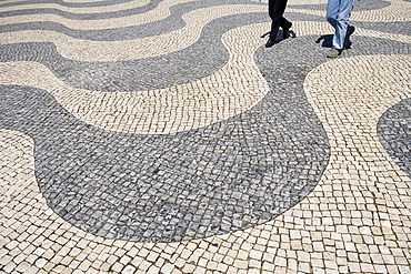 People walking on a typical Portuguese pavement, Portugal, Europe