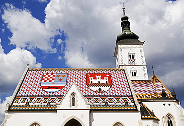 St Marks Church with coat of arms of Zagreb on the right and the shield of the Triune Kingdom of Croatia, Slavonia, and Dalmatia on the left of its tiled roof, Zagreb, Croatia, Europe