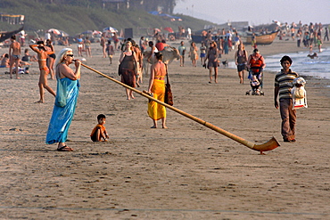 Woman playing the alphorn on the beach, Arambol, Goa, India, South Asia