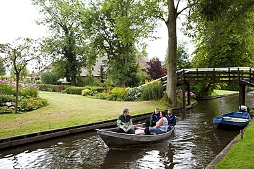 Tourists visiting a traditional Dutch village on a rented boat, Giethoorn, Flevoland, Netherlands, Europe