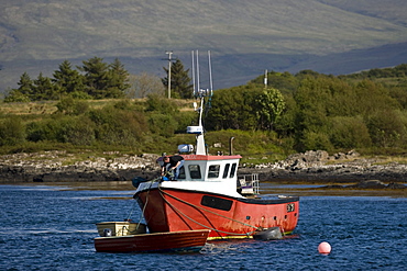 Fishing boat in the bay between the Isle of Mull and Ulva, Scotland, UK, Europe