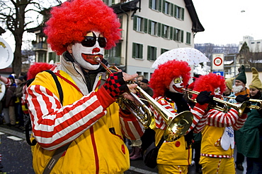 Clown playing the trumpet at the carnival parade in Malters, Lucerne, Switzerland, Europe