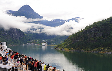 Cruise ship pulling into the port of Geiranger, Geirangerfjord, Norway, Scandinavia, Northern Europe, Europe