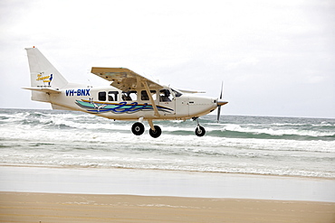 Aircraft landing on Seventy-Five Mile Beach, an official highway, the world's only official beach airport on a sand runway, UNESCO World Natural Heritage Site, Fraser Island, Great Sandy National Park, Queensland, Australia