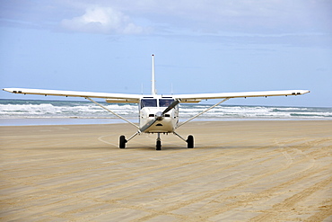 Aircraft on Seventy-Five Mile Beach, an official highway, the world's only official beach airport on a sand runway, UNESCO World Natural Heritage Site, Fraser Island, Great Sandy National Park, Queensland, Australia