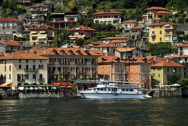 View towards a town with a tourist ferry over Lake Maggiore, Cannero Riviera, Piedmont, Italy, Europe