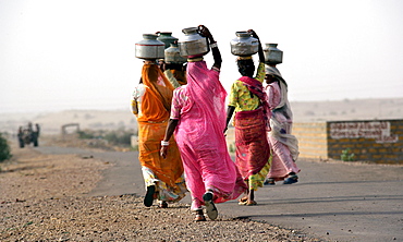 Indian women fetching water in the desert about 50 km away from Jaisalmer, Rajasthan, India