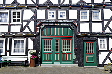 Ornate wooden door, entrance, half-timbered, house, Eversberg, Dorf, Meschede, Sauerland region, North Rhine-Westphalia, Germany, Europe