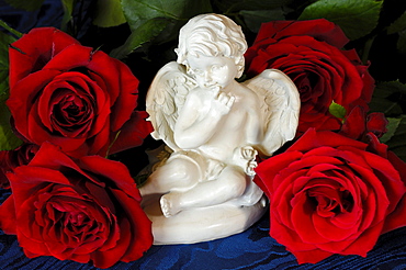 Ceramic angel figurine with red roses