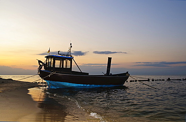 Fishing boat on the beach in the Bansin seaside resort, at dusk, Usedom Island, Mecklenburg-Western Pomerania, Germany, Europe