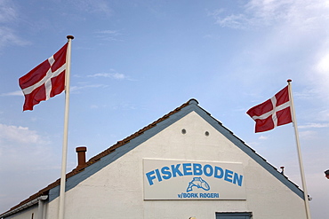 Danish flags on a small fish shop, in Bork Havn at Ringkoebing Fjord, West Jutland, Denmark, Europe