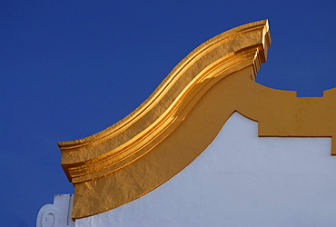 A yellow ornament on the roof of a church against a blue sky, Cordoba, Andalusia, Spain, Europe