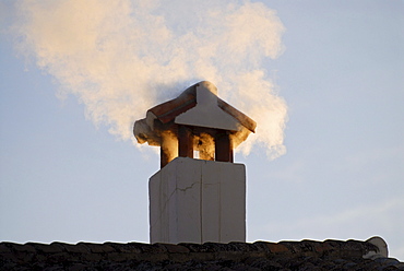 A fuming chimney in warm morning light, Ronda, Andalusia, Spain, Europe