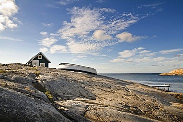 Green cabin with row boat, Smoegen, Bohuslaen, Sweden