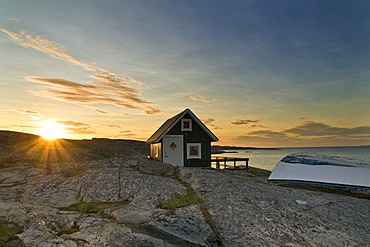 Cabin with row boat, sunset, Smoegen, Bohuslaen, Sweden