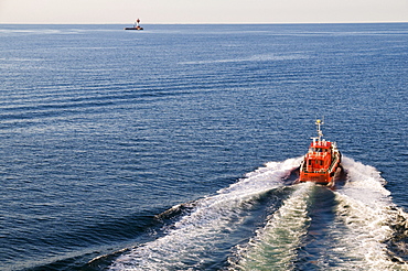 Pilot boat and lighthouse