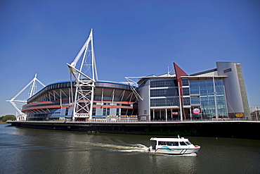 Millennium Stadium sports centre with boat on river, Cardiff, Wales, United Kingdom, Europe