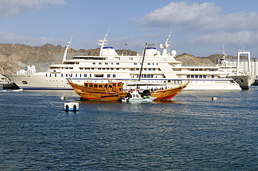 Old dhow and Sultan Qaboos royal yacht, Mutrah harbour, Muscat, Sultanate of Oman, Arabia, Middle East