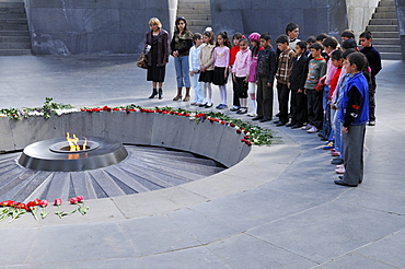 School children in the Armenian Genocide Memorial Tsitsernakaberd with eternal flame, Yerevan, Armenia, Asia