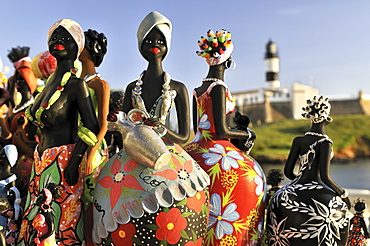 Traditional arts and crafts, clay figurines of women, and Forte de Santo Antonio da Barra fortress with Farol da Barra lighthouse, Salvador, Bahia, UNESCO World Heritage Site, Brazil, South America