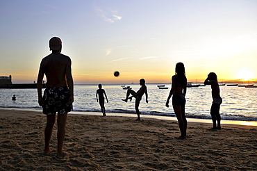 Football at sunset on the beach of Porto da Barra, Salvador, Bahia, Brazil, South America