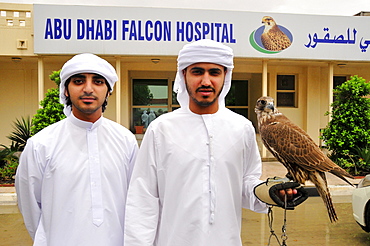 Two locals with their falcons at the Abu Dhabi Falcon Hospital, Abu Dhabi, United Arab Emirates, Arabia, Middle East, Orient