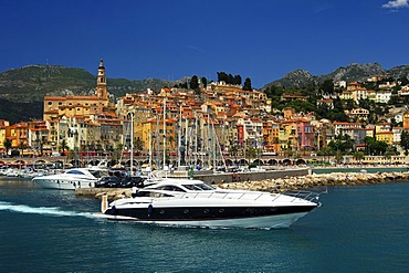 Luxury yacht leaving the old port of Menton, Cote d'Azur, France